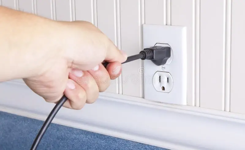 &quot;a hand pulling the cord out of the wall socket&quot;