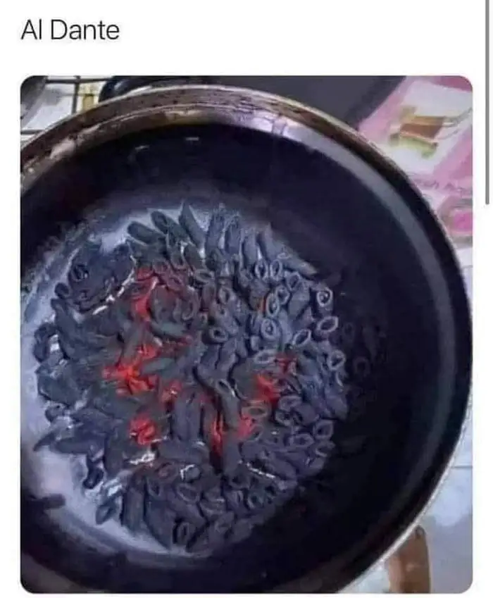 caption: Al Dante. A pot of penne cooking on the stove - gone so far that it&#39;s 100% charcoal and glowing orange in parts
