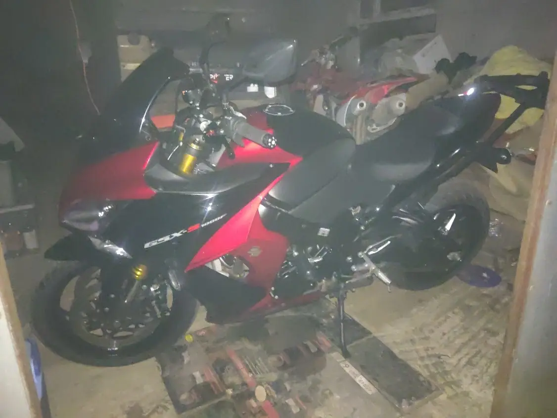 Grainy photo of a red and black Suzuki