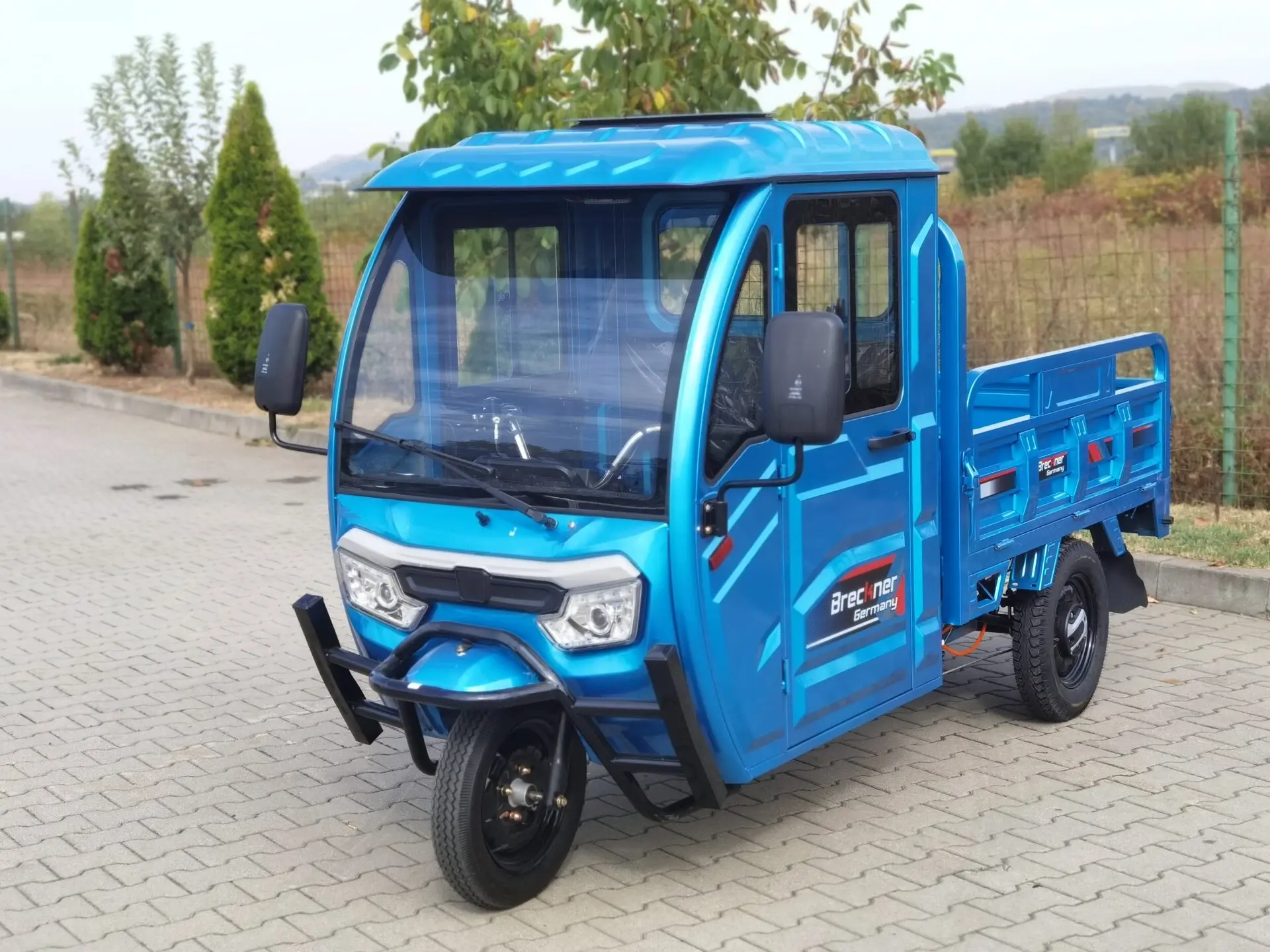 blue work tricycle that resembles a knock-off kei truck