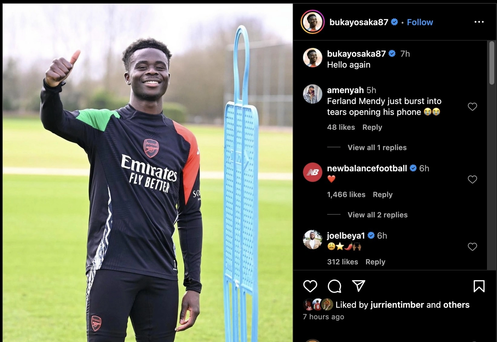 Bukayo Saka is giving a thumbs up while smiling, wearing an Arsenal training shirt. In the background, there is training equipment and a grassy field. The image is accompanied by social media comments.