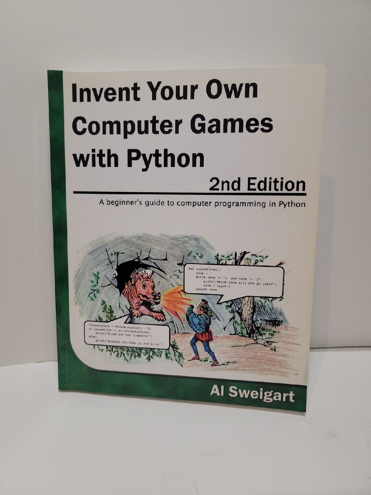 A copy of Invent Your own Computer Games with Python, 2nd edition by Al Sweigart.

It shows a... medieval? renaissance? knight attacking a.... dragon? landborn seahorse? breathing fire from a cave.