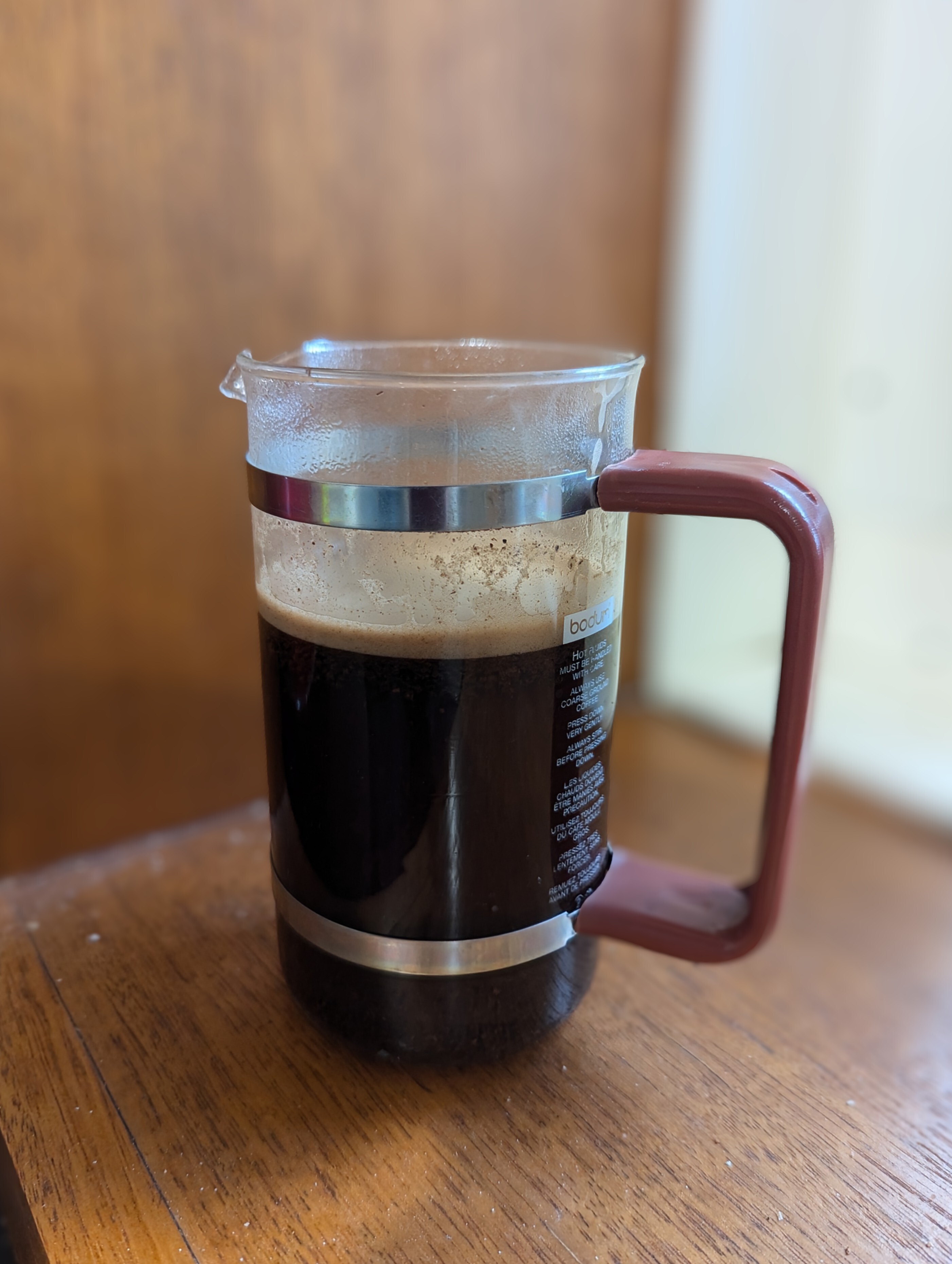 coffee plunger (french press) sans plunger with coffee 3/4 full